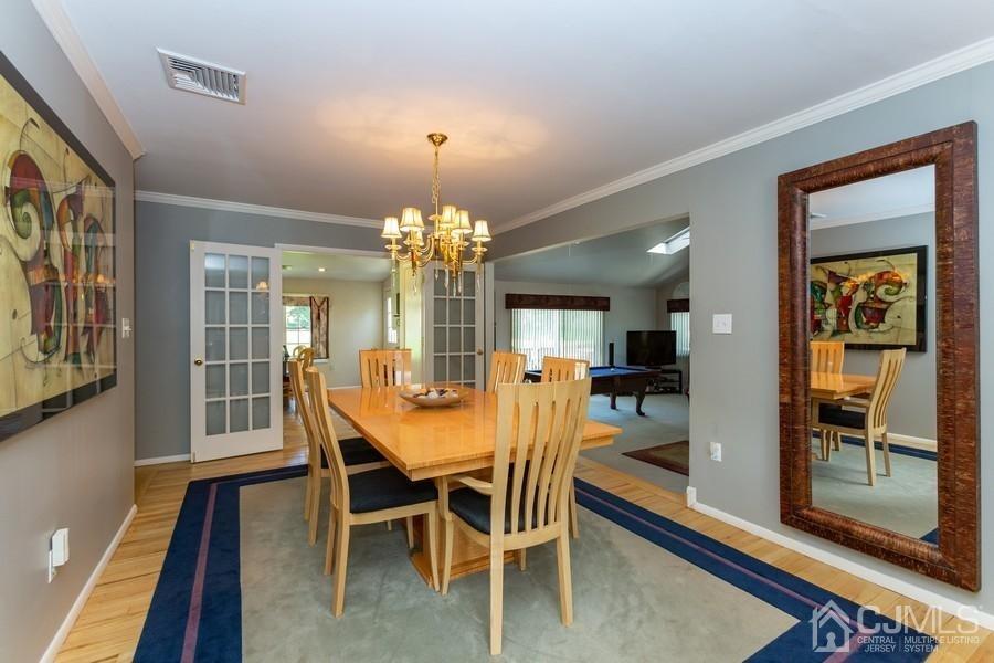33 Southfield Road Edison, NJ 08820 - Photo 15 of 36 a view of a dining room with furniture a chandelier and wooden floor