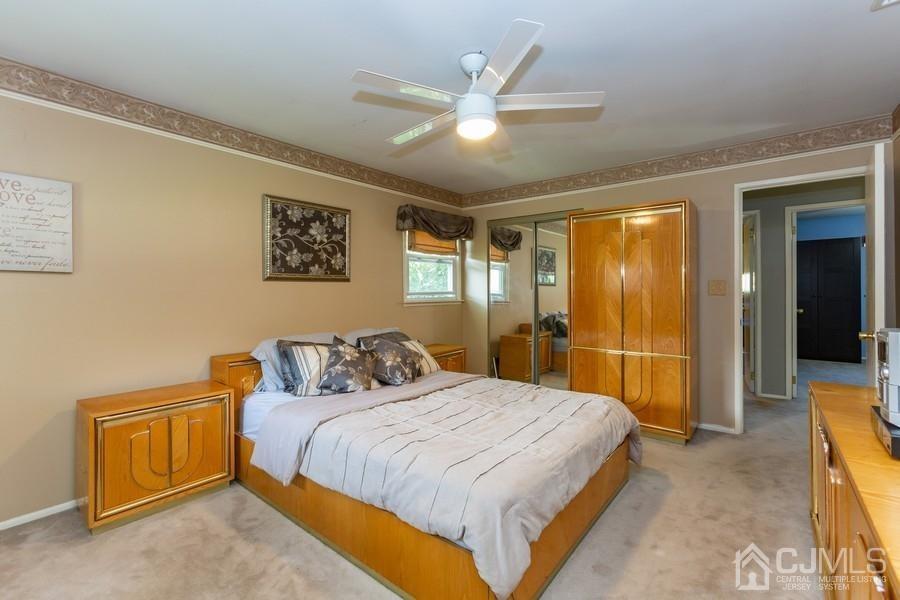 33 Southfield Road Edison, NJ 08820 - Photo 19 of 36 a bedroom with a large bed and a chandelier