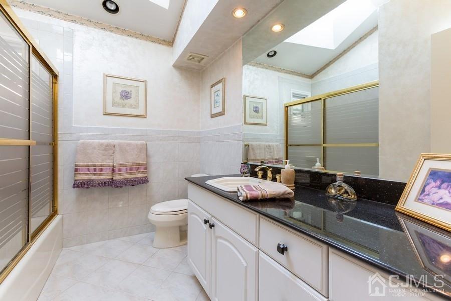 33 Southfield Road Edison, NJ 08820 - Photo 20 of 36 a bathroom with a granite countertop sink mirror vanity and toilet