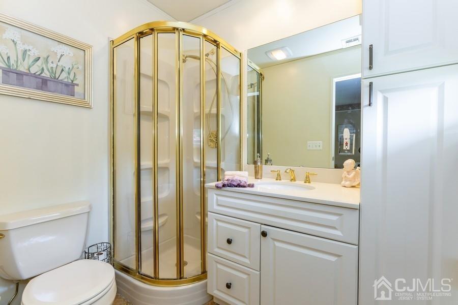33 Southfield Road Edison, NJ 08820 - Photo 21 of 36 a bathroom with a granite countertop sink a toilet and a mirror