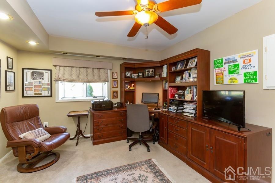 33 Southfield Road Edison, NJ 08820 - Photo 24 of 36 a work room with furniture a flat screen tv and a window