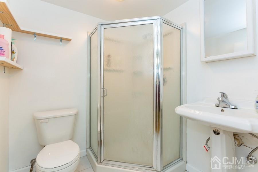 33 Southfield Road Edison, NJ 08820 - Photo 25 of 36 a bathroom with a sink a toilet and shower