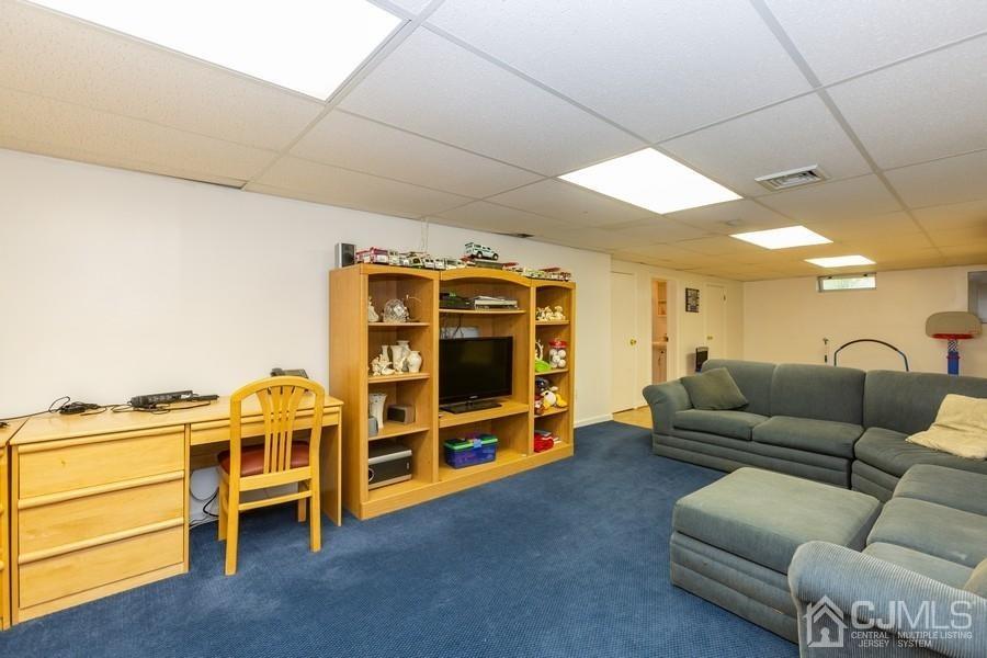 33 Southfield Road Edison, NJ 08820 - Photo 26 of 36 a living room with furniture and a flat screen tv