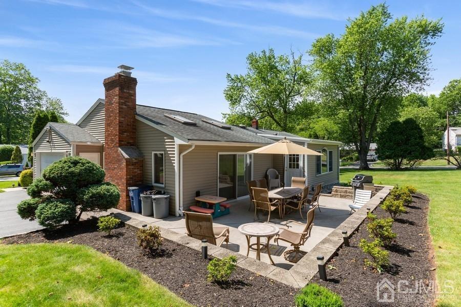 33 Southfield Road Edison, NJ 08820 - Photo 6 of 36 a view of a patio with furniture potted plants and a large tree