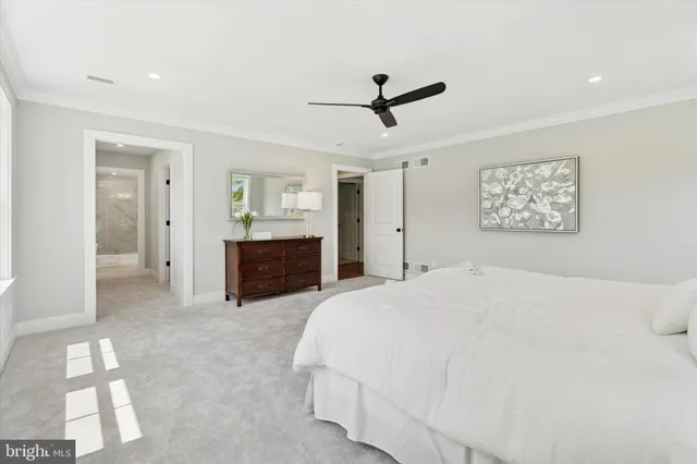 a spacious bedroom with a bed and a chandelier