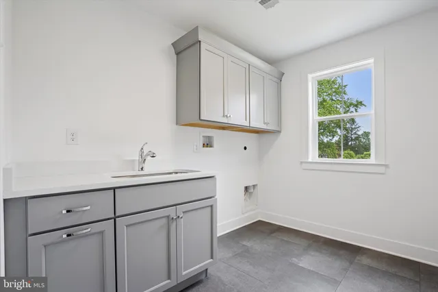 a bathroom with a sink and cabinets