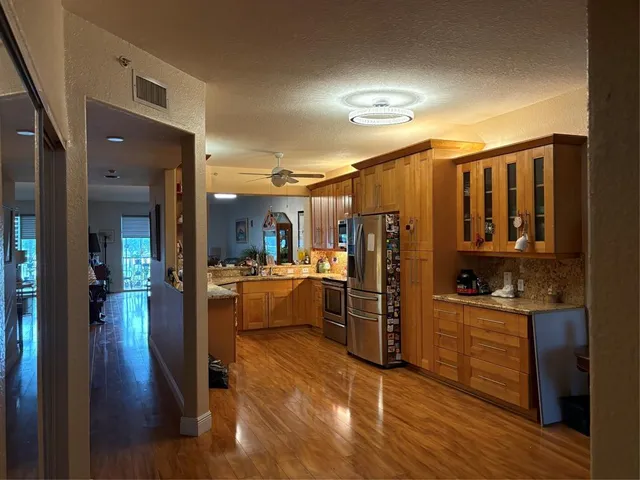a view of a living room kitchen and a wooden floor