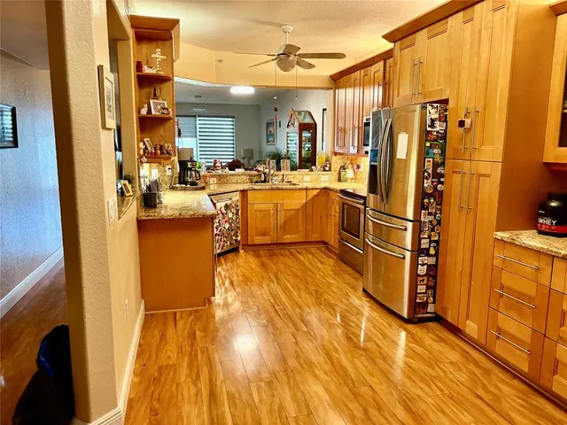 a kitchen with sink a counter top space and stainless steel appliances