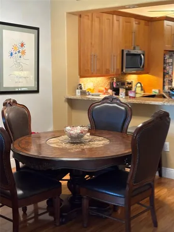 a dining room with furniture and wooden floor