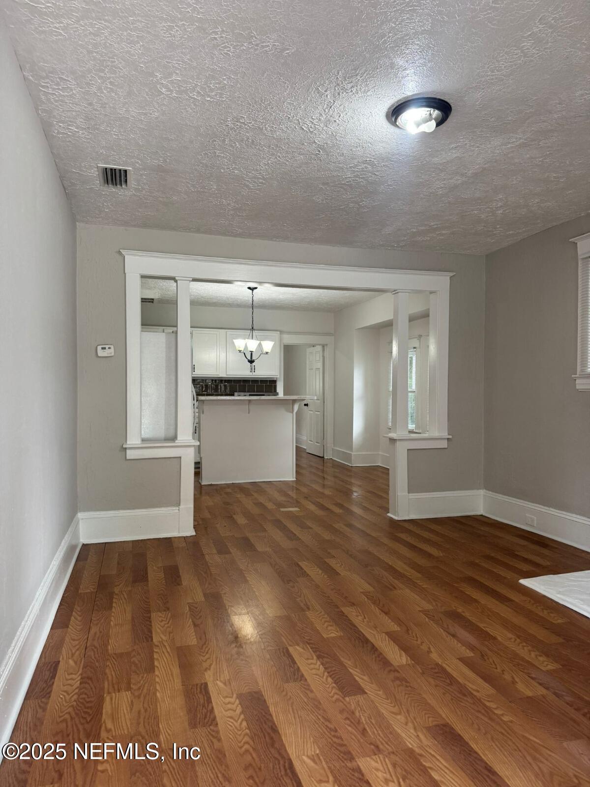 340 West 23rd Street Jacksonville, FL 32206 - Photo 2 of 13 a view of empty room with wooden floor and kitchen
