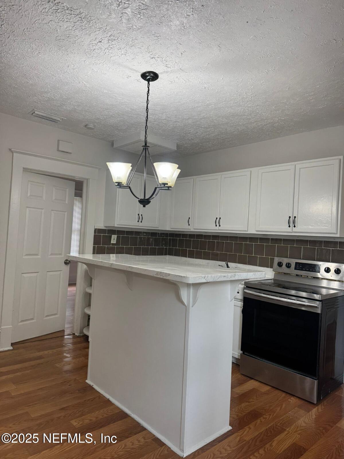 340 West 23rd Street Jacksonville, FL 32206 - Photo 4 of 13 a kitchen with stainless steel appliances granite countertop a sink a stove and white cabinets