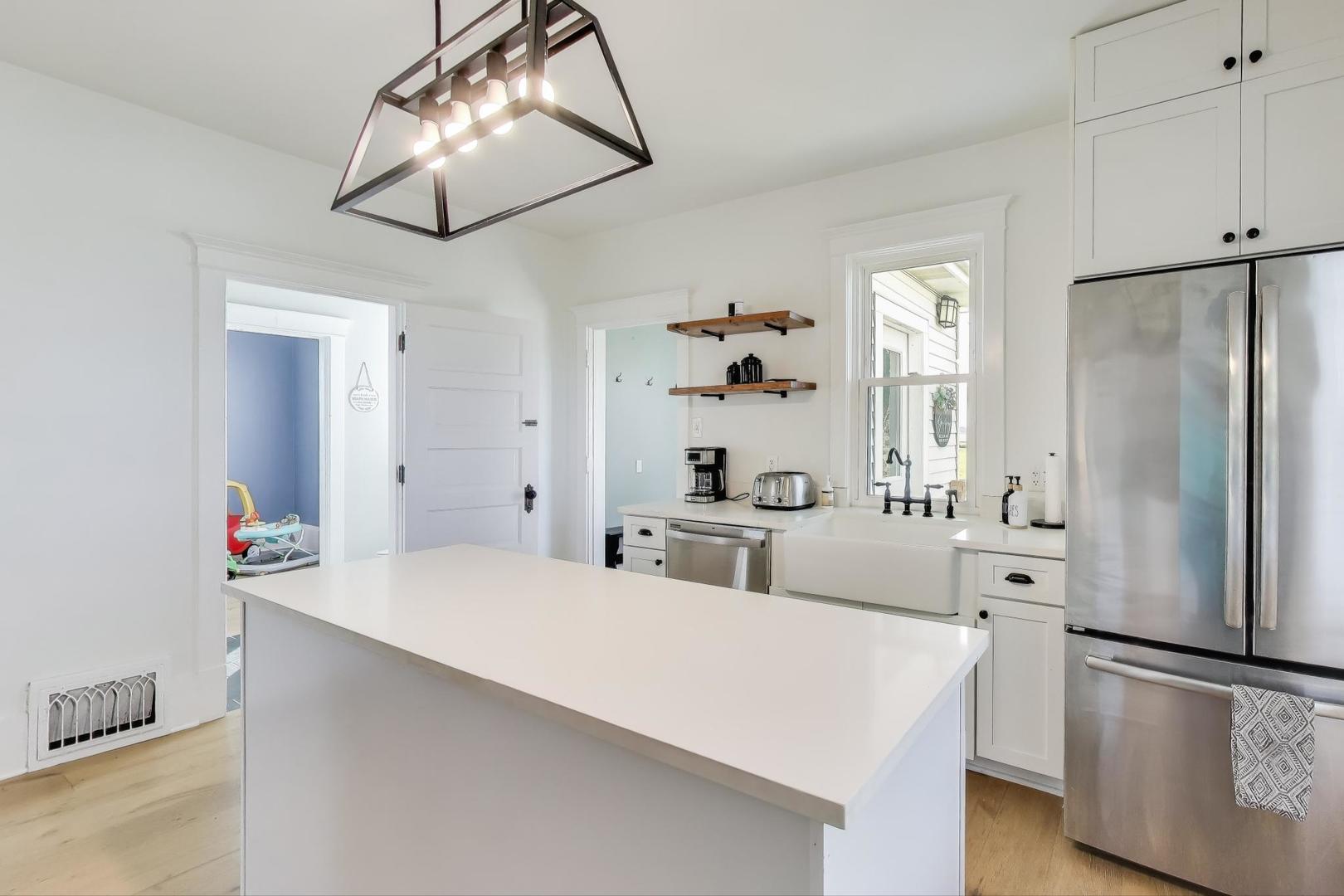 17128 Lukens Road Sycamore, IL 60178 - Photo 14 of 45 a large white kitchen with stainless steel appliances a refrigerator and a chandelier