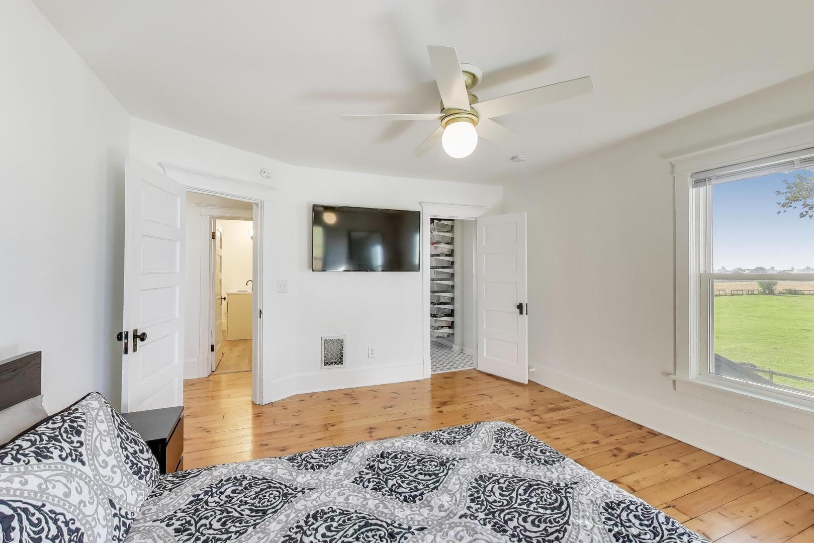 17128 Lukens Road Sycamore, IL 60178 - Photo 21 of 45 a bedroom with a bed and wooden floor