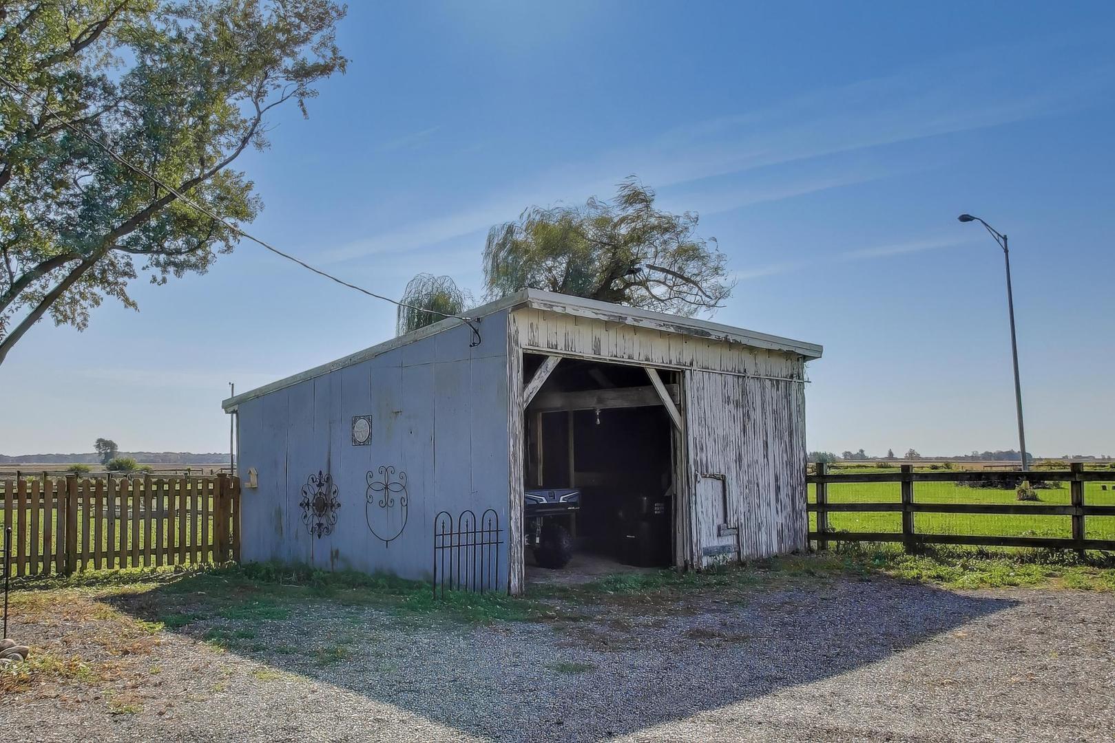 17128 Lukens Road Sycamore, IL 60178 - Photo 35 of 45 a view of a tiny house with a small yard and fence