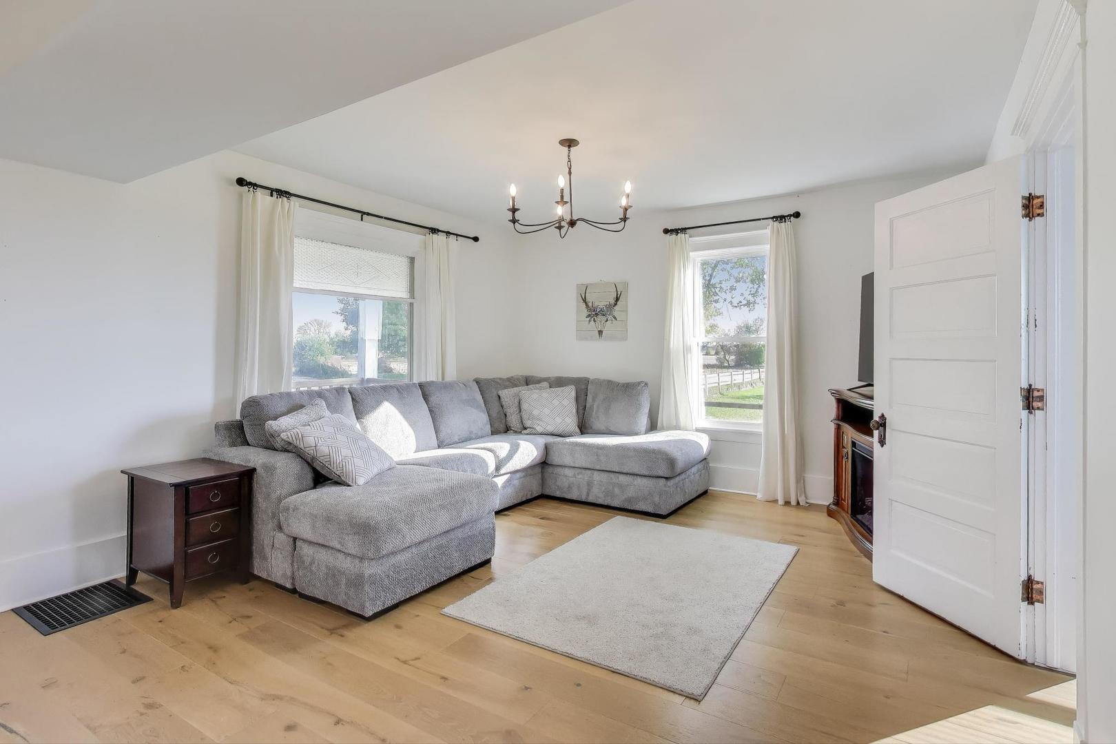 17128 Lukens Road Sycamore, IL 60178 - Photo 7 of 45 a living room with furniture and a chandelier