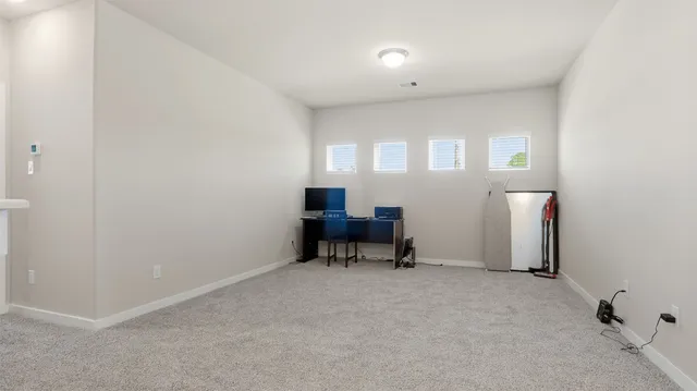 a view of a livingroom with furniture and a window