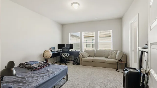 a living room with furniture rug and a window