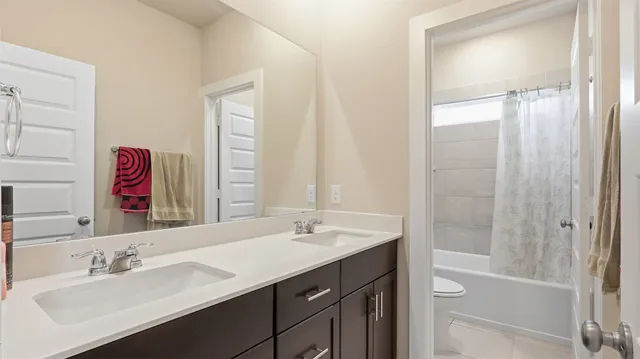 a bathroom with a tub sink and mirror