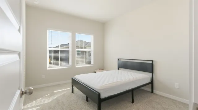 a bedroom with a bed and window