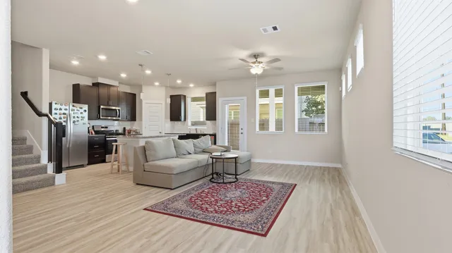 a living room with furniture and a wooden floor