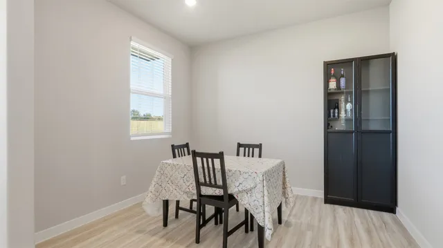 a view of a room with furniture and wooden floor