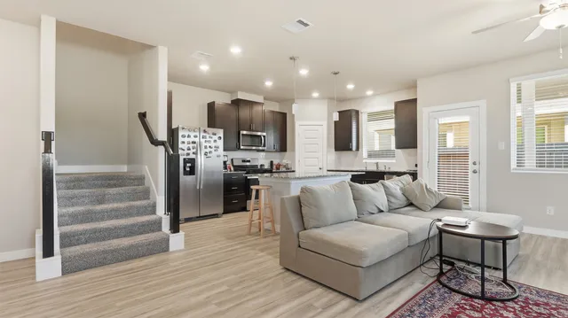 a living room with furniture and kitchen view