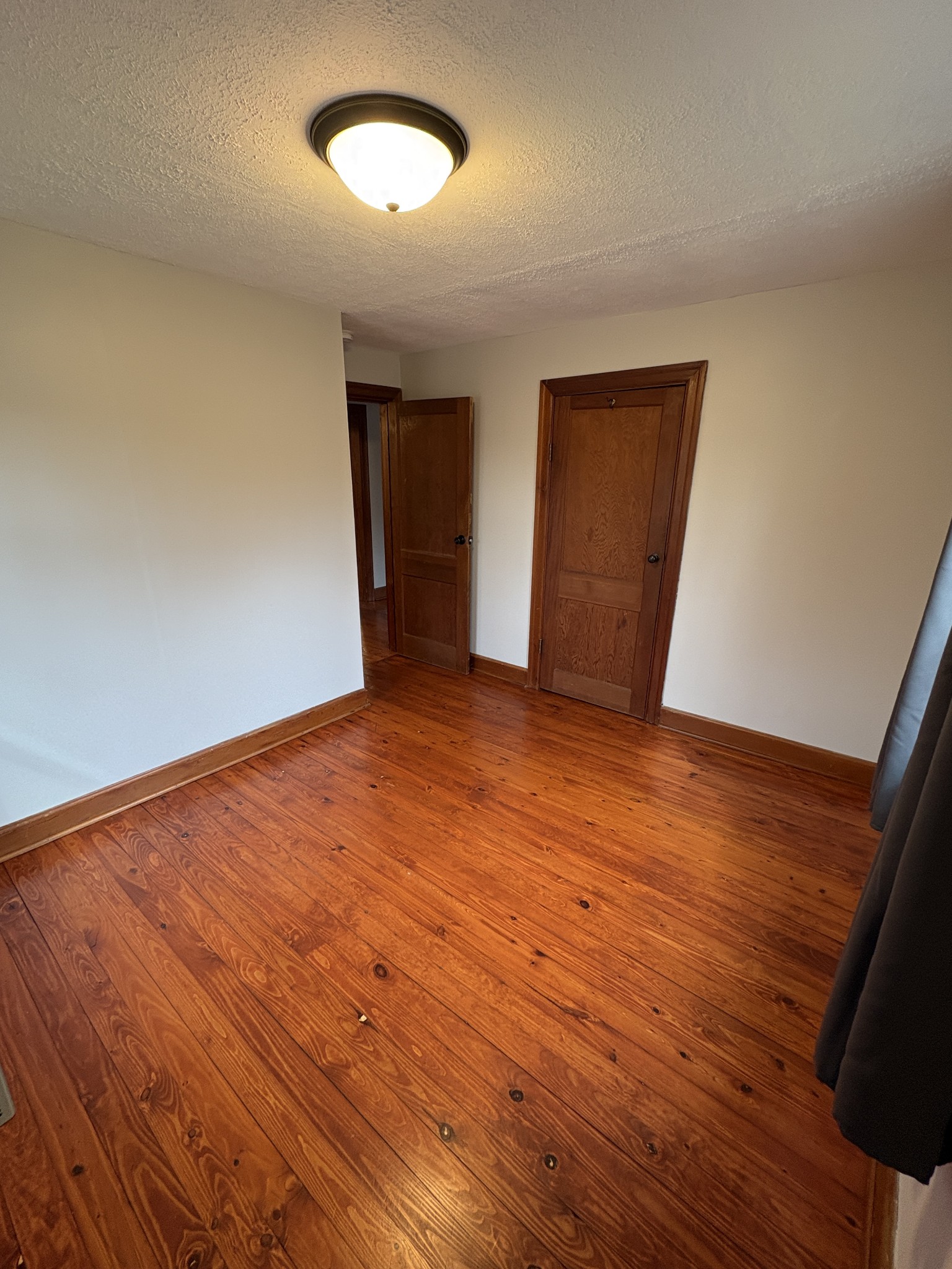 1546 Bobby Road Clarksville, TN 37040 - Photo 11 of 21 an empty room with wooden floor and windows