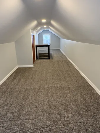 a view of empty room with a fireplace