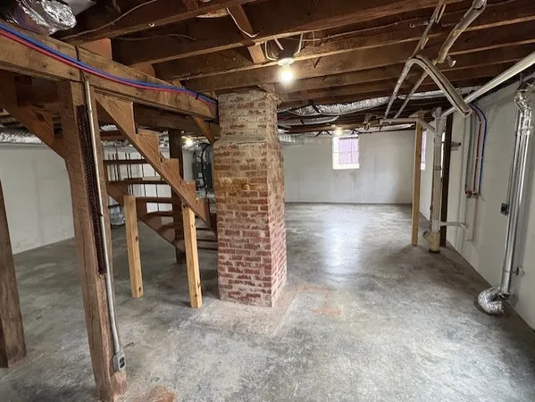a view of water heater room with stairs