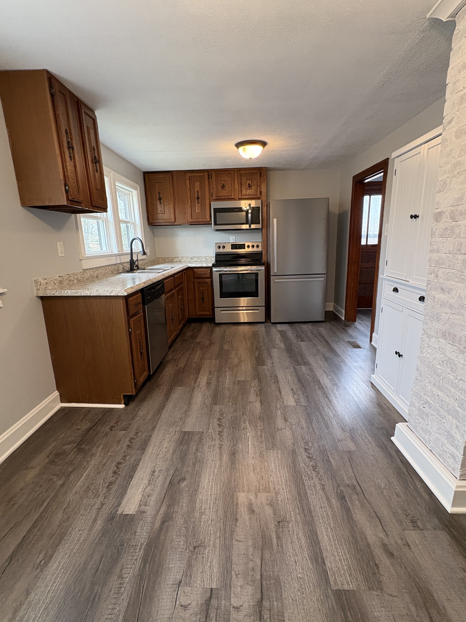 1546 Bobby Road Clarksville, TN 37040 - Photo 5 of 21 a kitchen with wooden floors and appliances