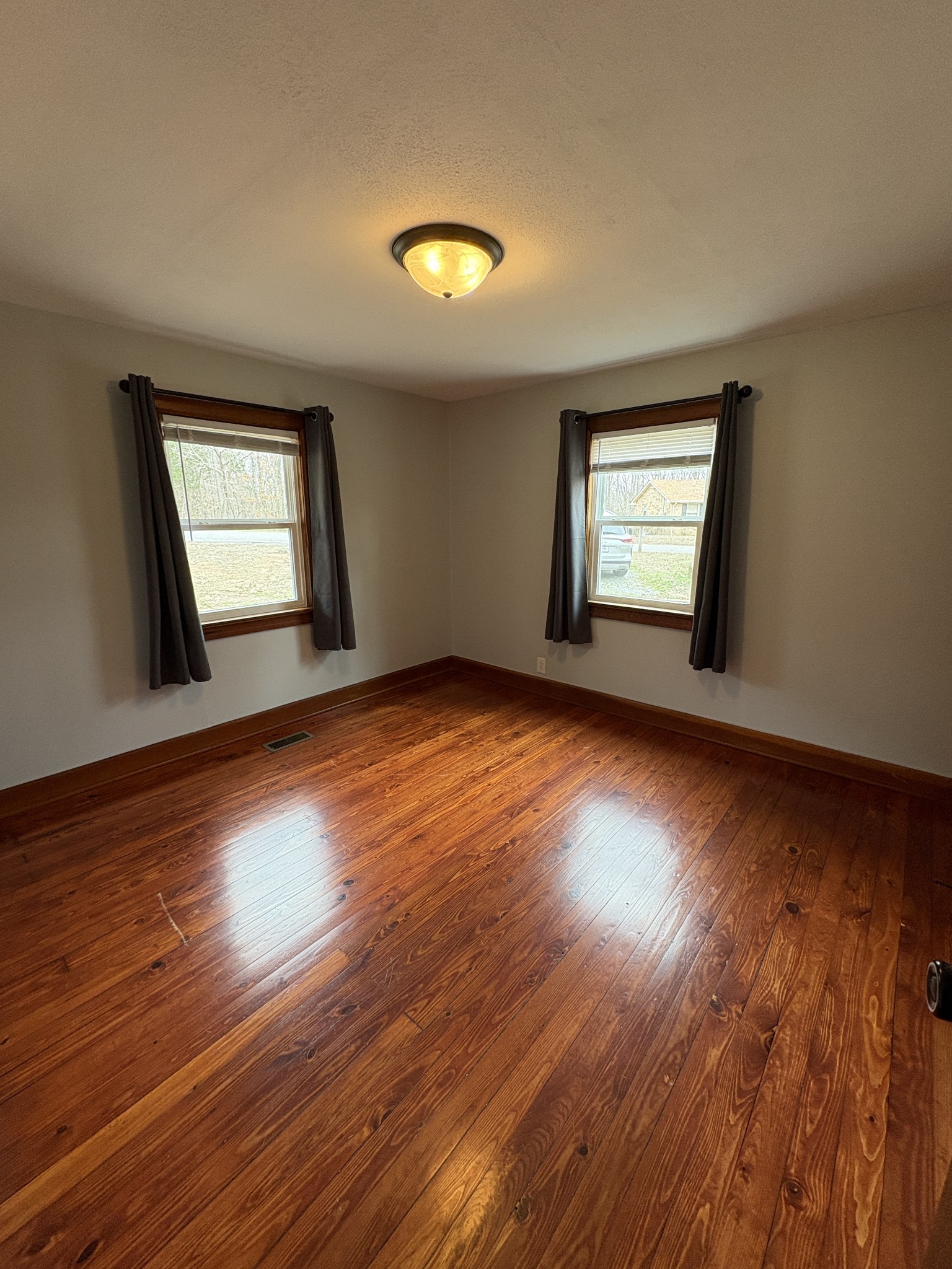 1546 Bobby Road Clarksville, TN 37040 - Photo 9 of 21 an empty room with wooden floor and windows