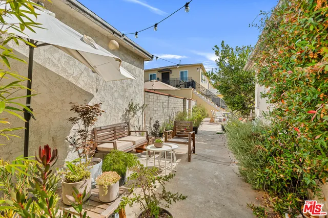 a view of a patio with table and chairs and potted plants