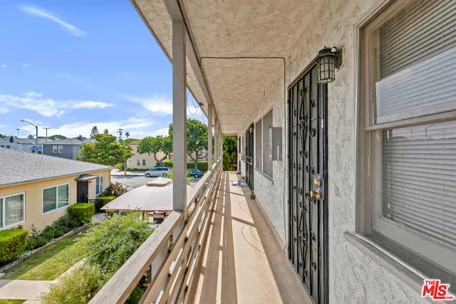 a view of balcony with wooden floor and fence