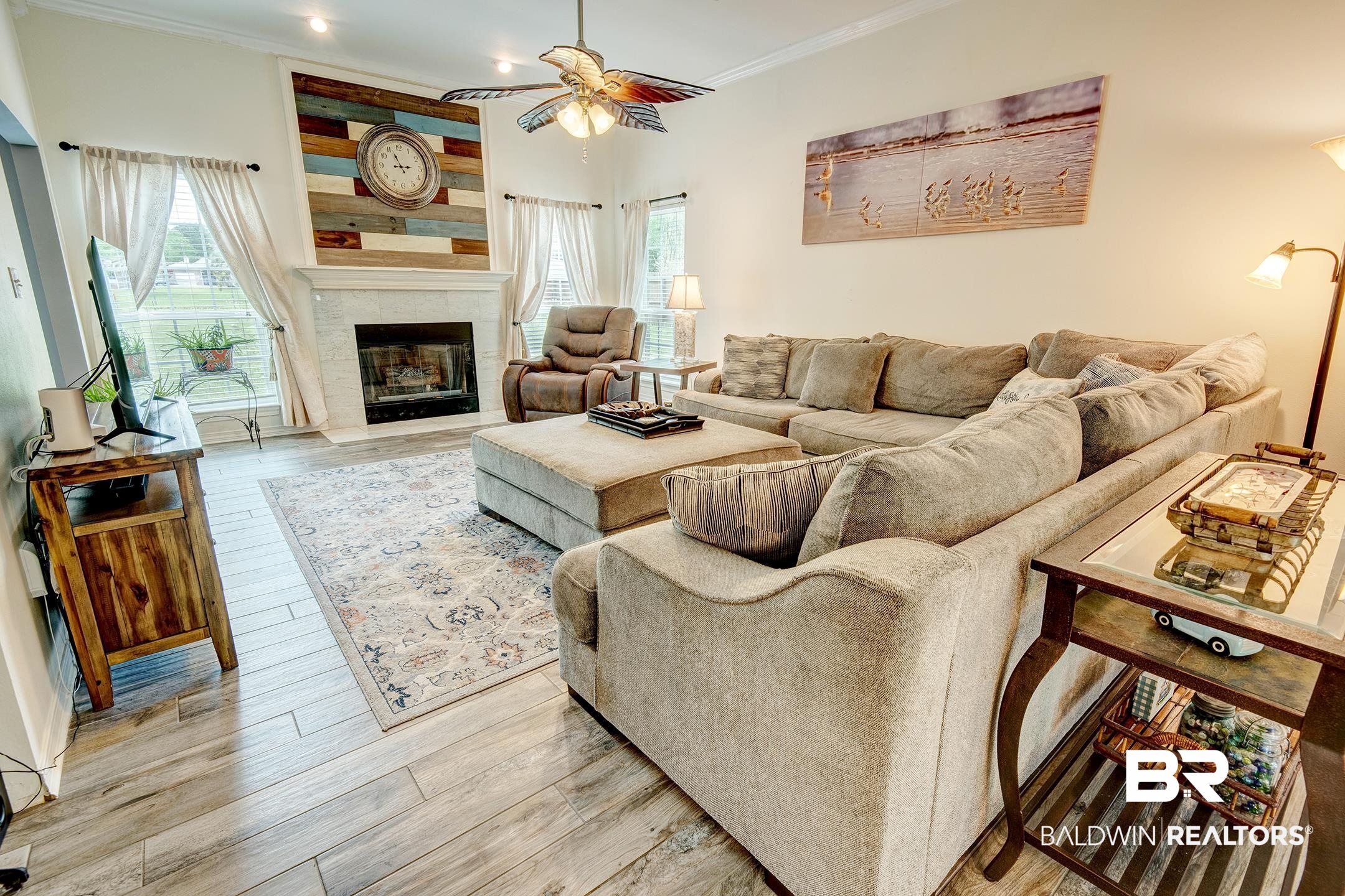10093 Willis Road Foley, AL 36535 - Photo 23 of 33 Living room with light wood-style floors, ceiling fan, ornamental molding, and a fireplace