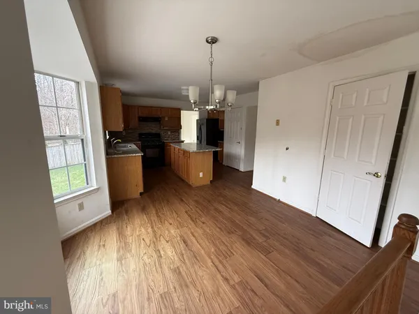 a view of a livingroom with furniture window and wooden floor