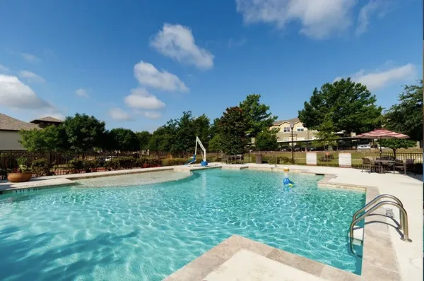 a view of a house with swimming pool and a yard