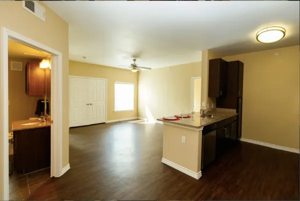 a view of a room with wooden floor