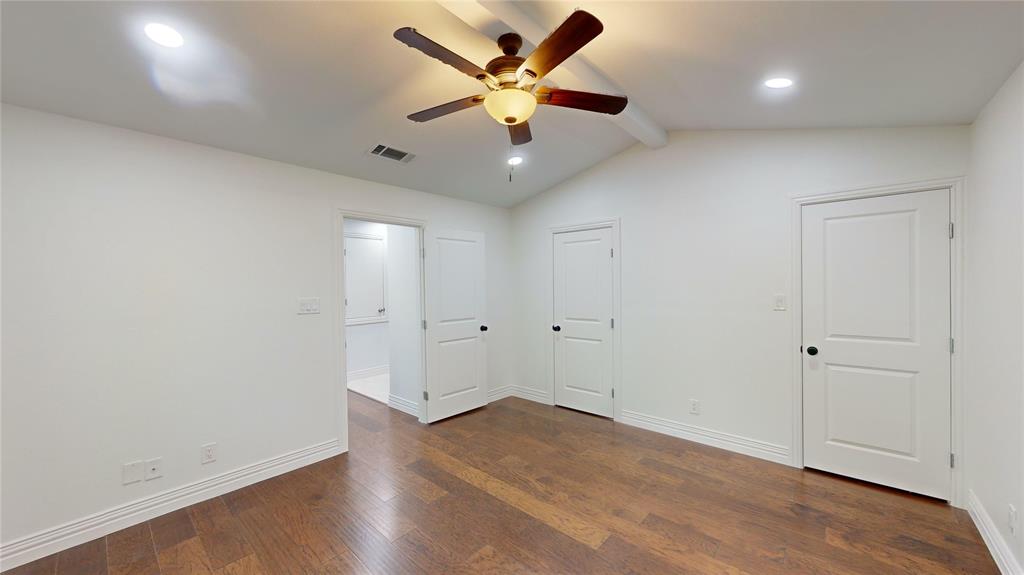 8545 Midpark Road, Unit 10 Dallas, TX 75240 - Photo 14 of 31 an empty room with wooden floor and ceiling fan