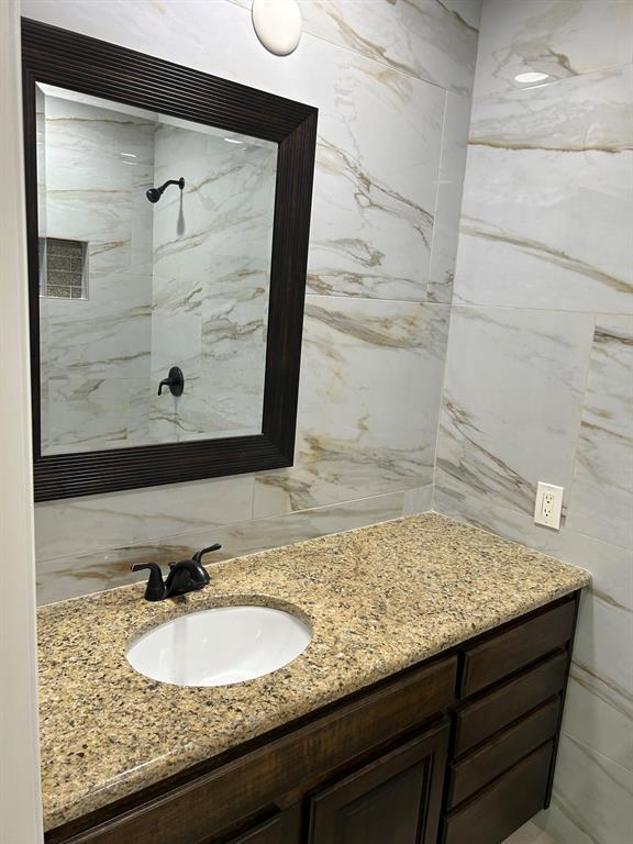 8545 Midpark Road, Unit 10 Dallas, TX 75240 - Photo 16 of 31 a bathroom with a granite countertop sink and mirror