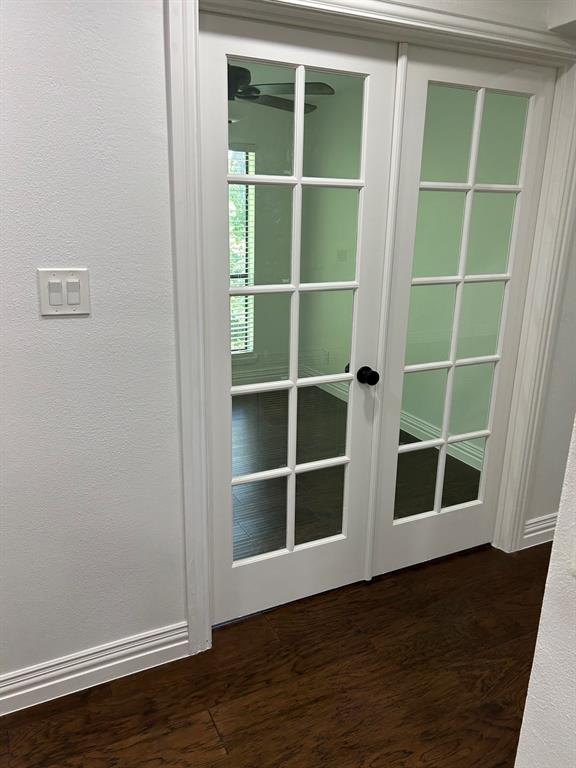 8545 Midpark Road, Unit 10 Dallas, TX 75240 - Photo 23 of 31 a view of an empty room with wooden floor and windows
