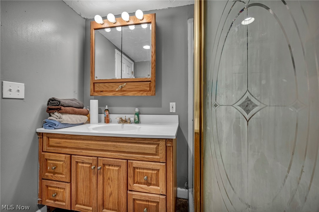 13800 Milo Road Garfield Heights, OH 44125 - Photo 23 of 39 Bathroom with vanity and a shower