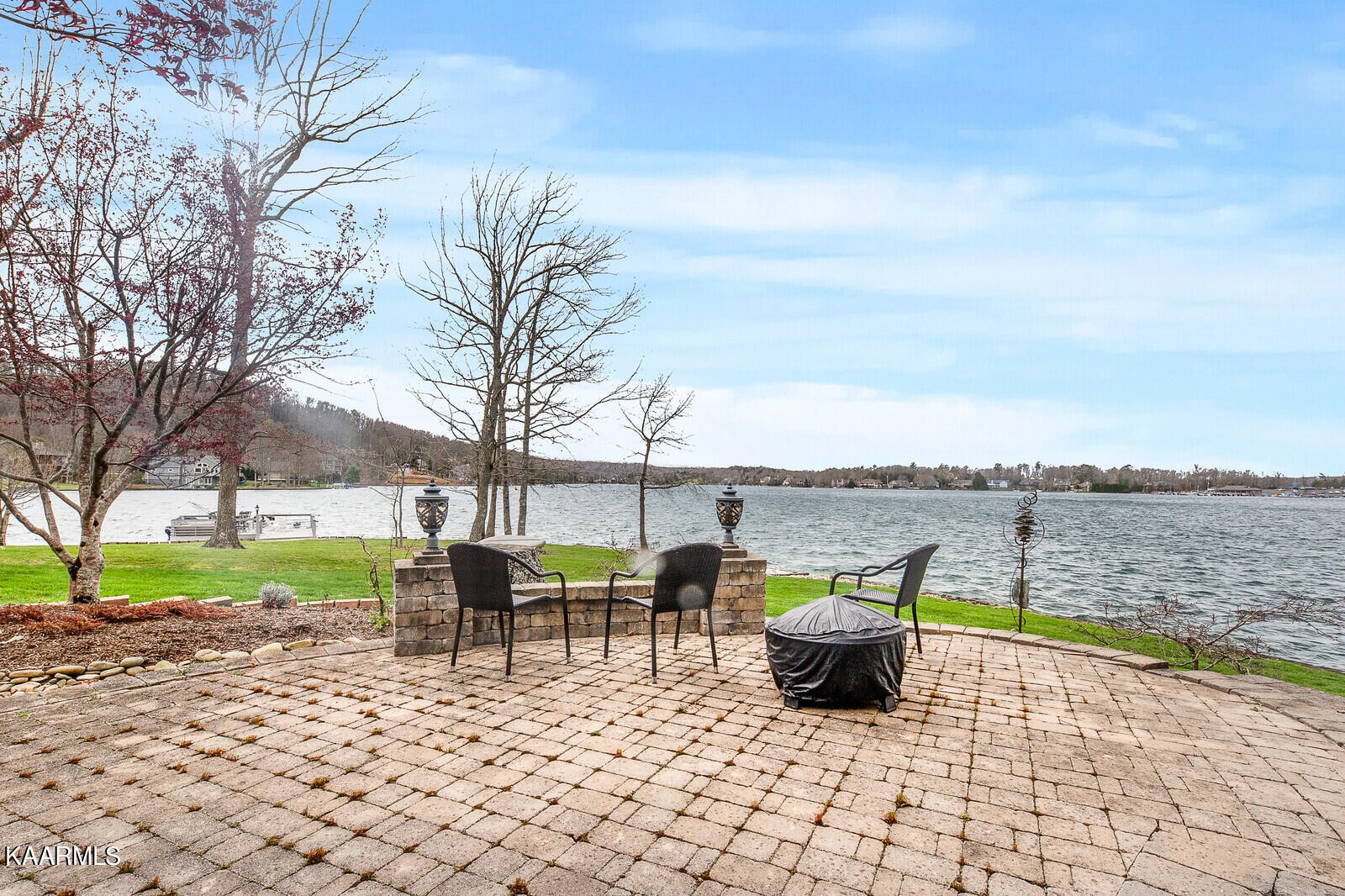 16 Milnor Circle Crossville, TN 38558 - Photo 43 of 50 a chairs sitting on a pier next to a yard with large trees