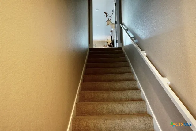 a living room with furniture a flat screen tv and a stove