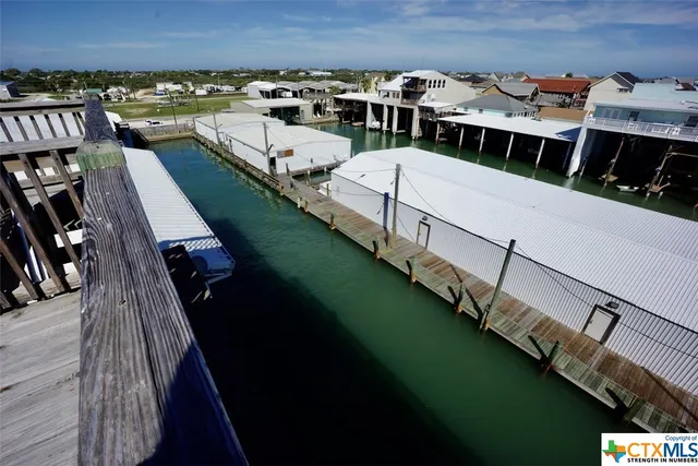 a view of a balcony with wooden chairs