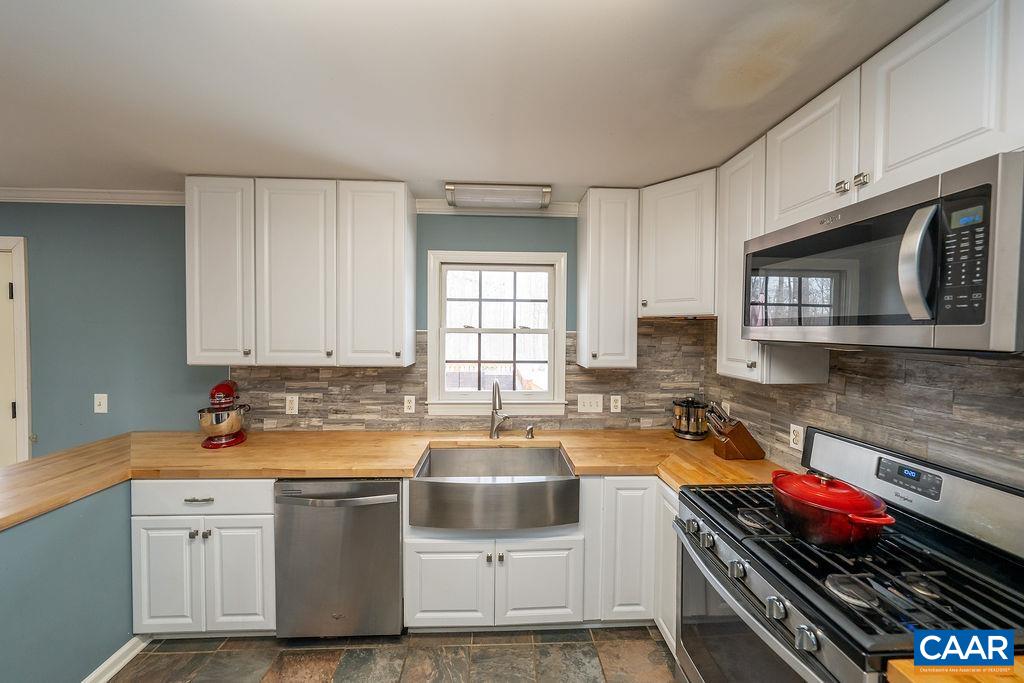 1425 Jacks Shop Road Rochelle, VA 22738 - Photo 18 of 66 a kitchen with a stove a sink and a microwave