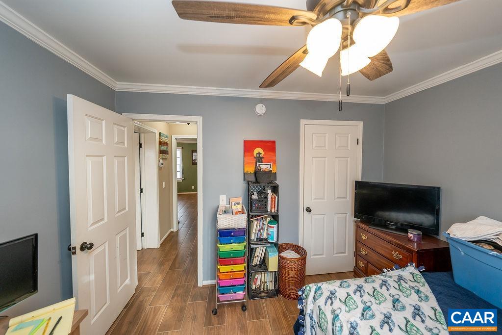 1425 Jacks Shop Road Rochelle, VA 22738 - Photo 36 of 66 a bedroom with furniture a flat screen tv and a chandelier