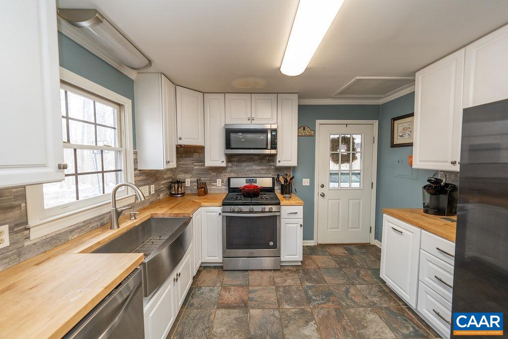 1425 Jacks Shop Road Rochelle, VA 22738 - Photo 5 of 66 a kitchen with stainless steel appliances granite countertop a stove top oven a sink dishwasher a refrigerator and a oven with wooden floor