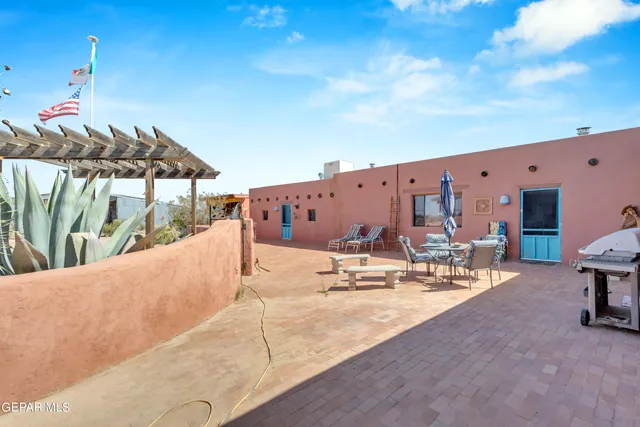 a view of a patio with a table and chairs
