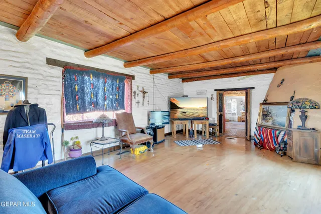 a living room with lots of furniture and a wooden floor