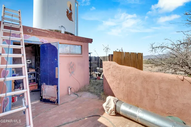 a backyard of a house with table and chairs